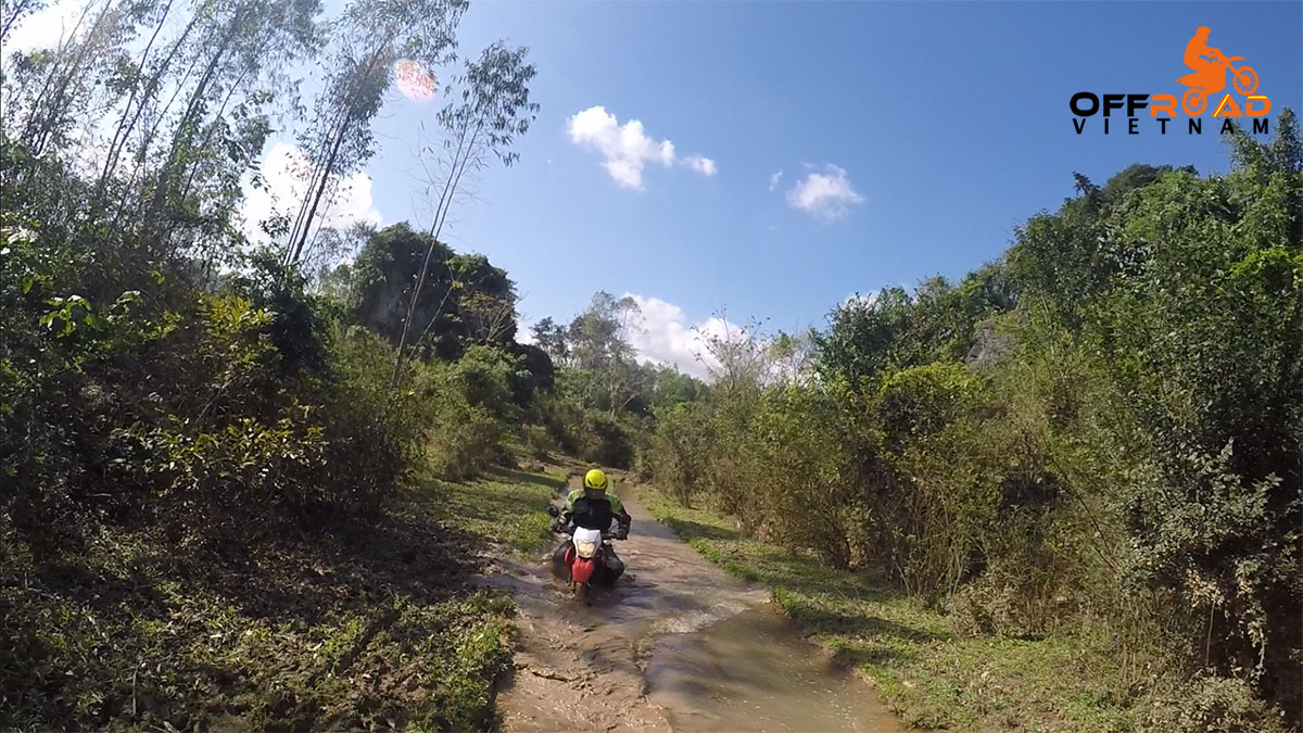Vietnam Motorbike Motorcycle Tours - Ho Chi Minh Trail Motorbike Tour on a dirt track.