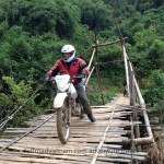 Riding a dirt bike over a bamboo bridge in Northeast Vietnam